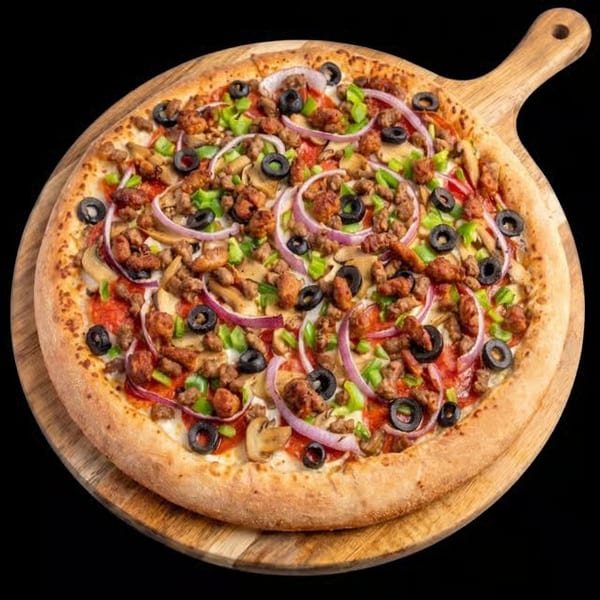 A whole pizza with sausage, mushrooms, green peppers, red onions, and black olives on a wooden peel.