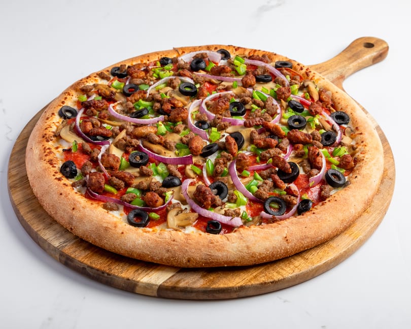 A whole pizza with pepperoni, sausage, mushrooms, green peppers, red onions, and black olives.
